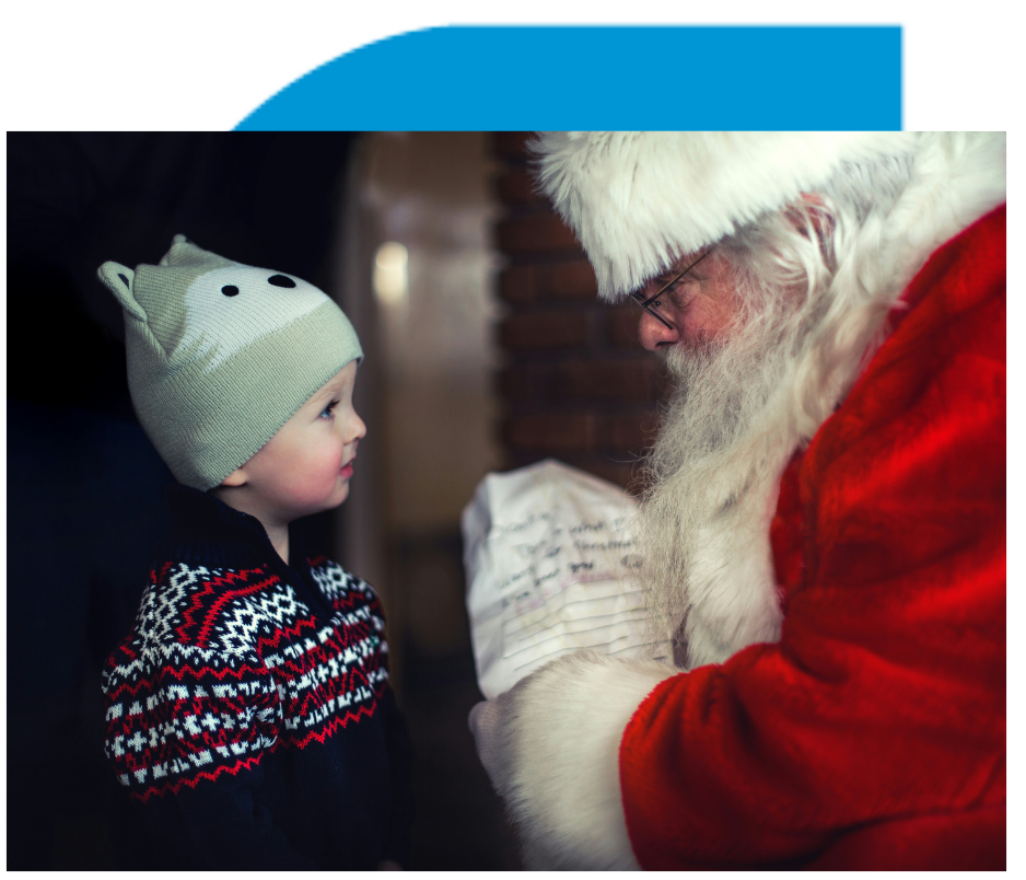 Santa Claus standing in front of a child holding a list